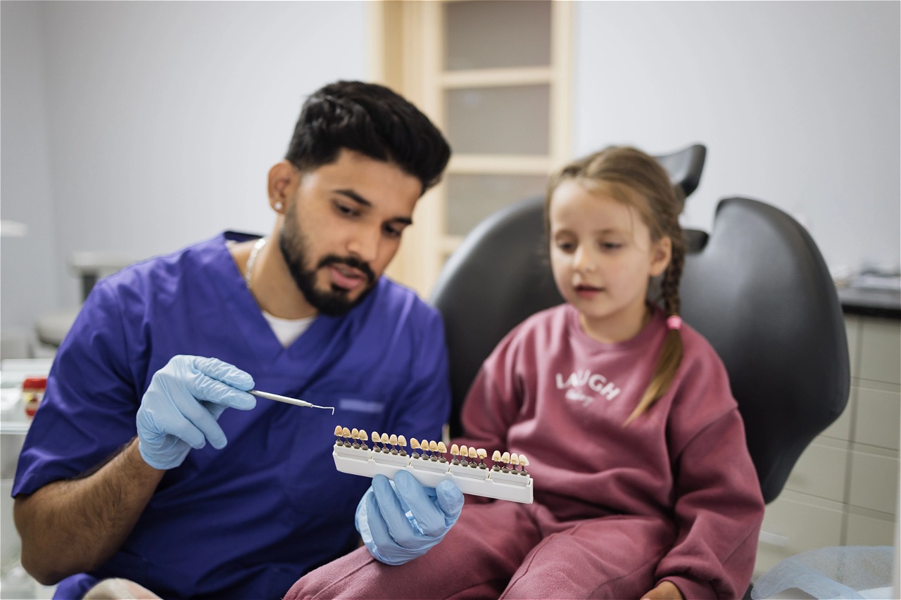 professional-male-dentist-choosing-color-of-fillin-2024-12-12-06-29-30-utc